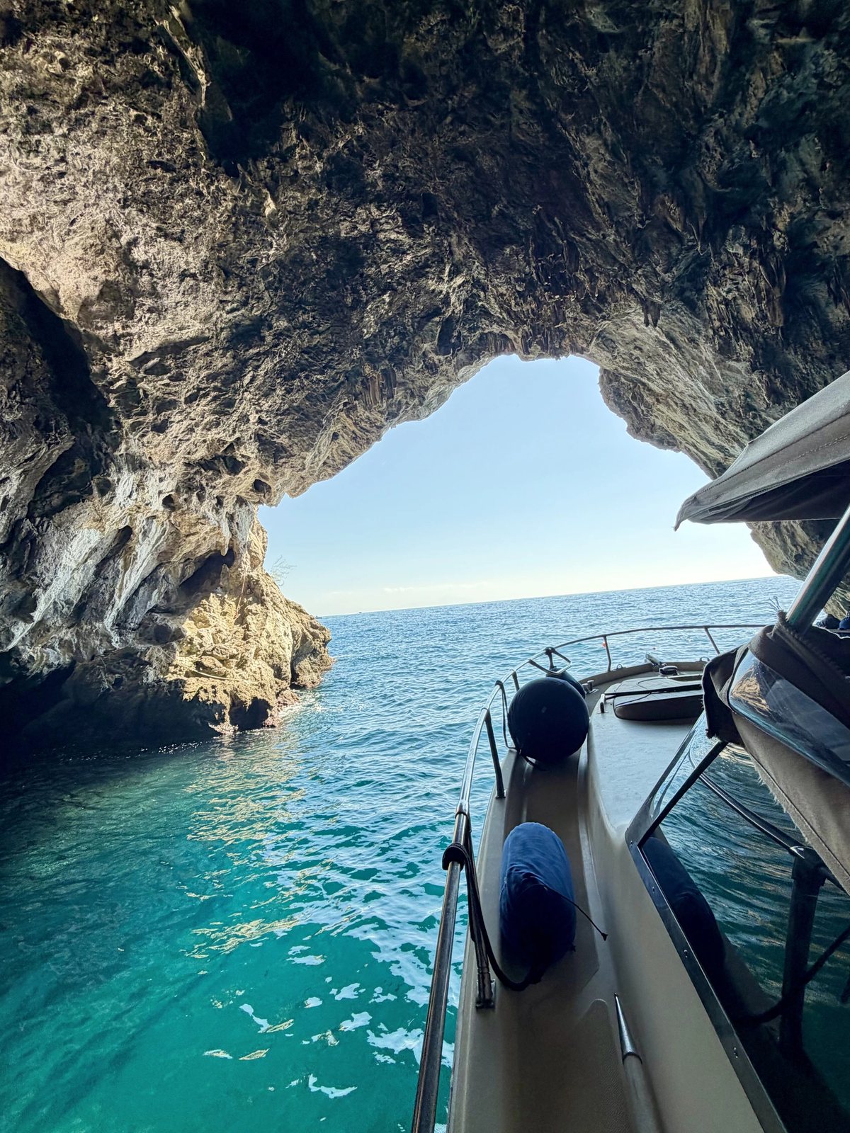 Grotta con acqua azzurra illuminata dal sole, visitabile in barca